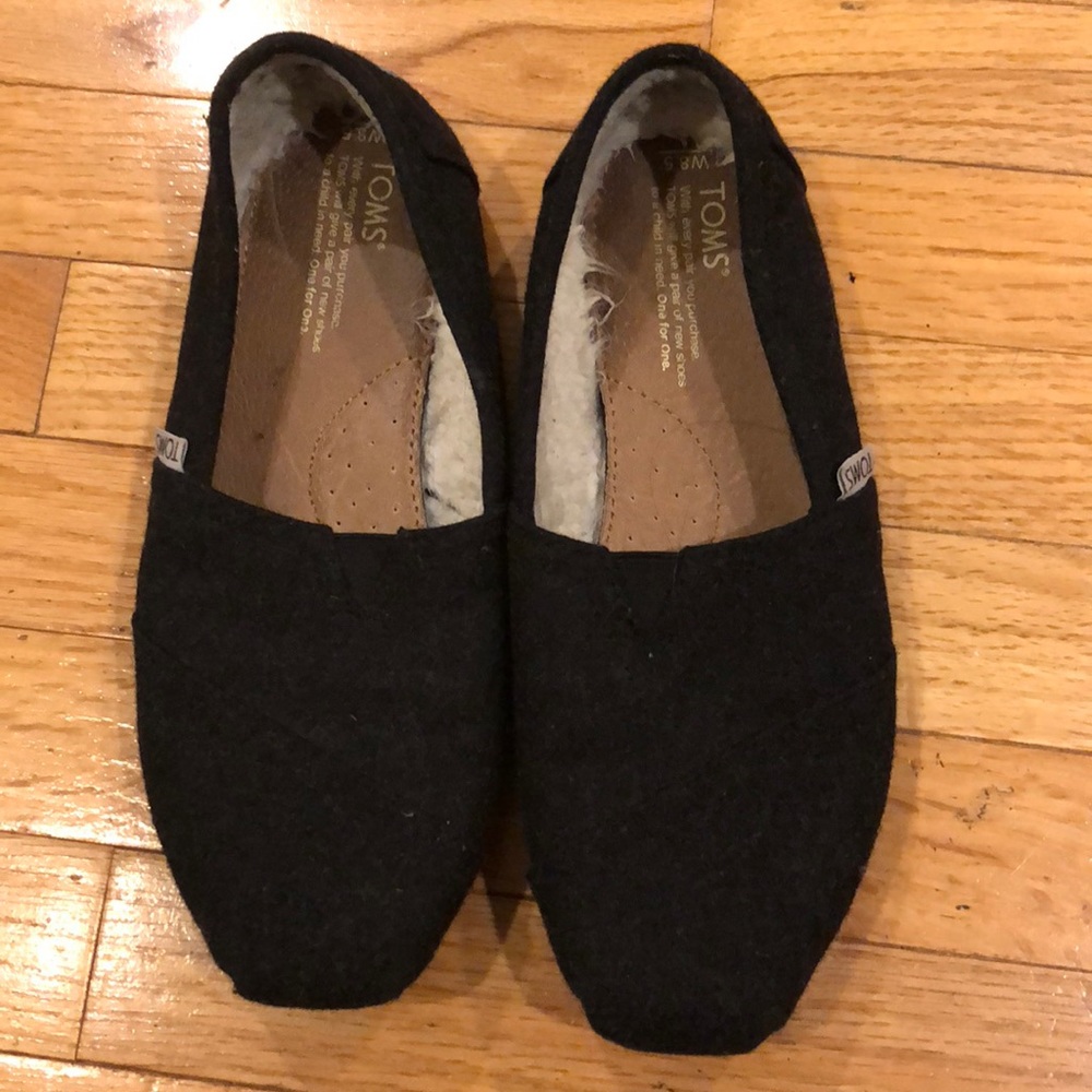 Toms fuzzy black slip ons